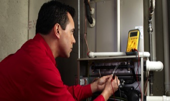 Residential Furnace repair being performed by technician.